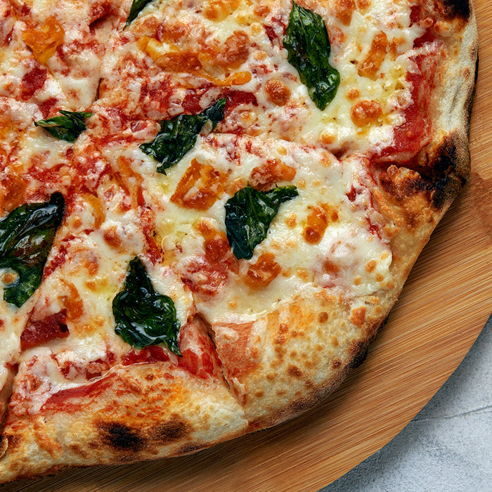 Pizza topped with bacon, basil, and caramelized onions