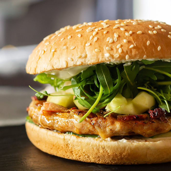 Apple Pork Burger on a dark table top 