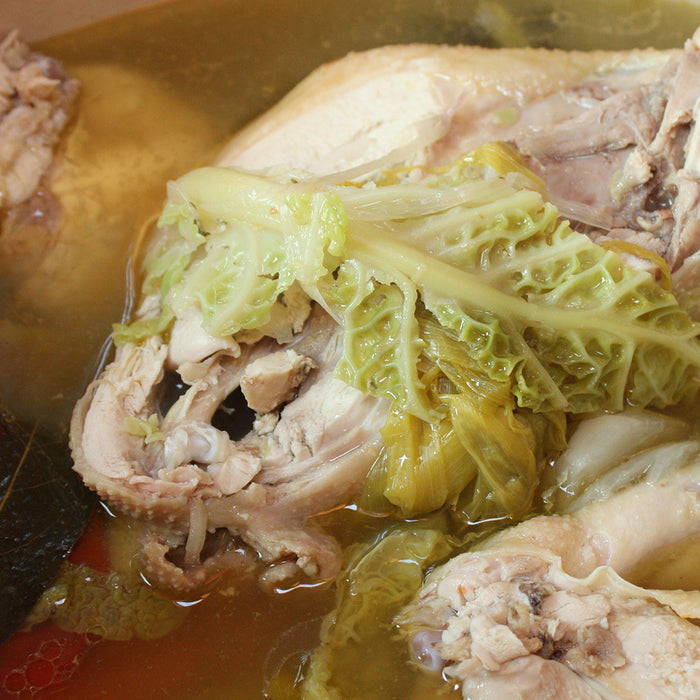 Braised chicken in a stock pot