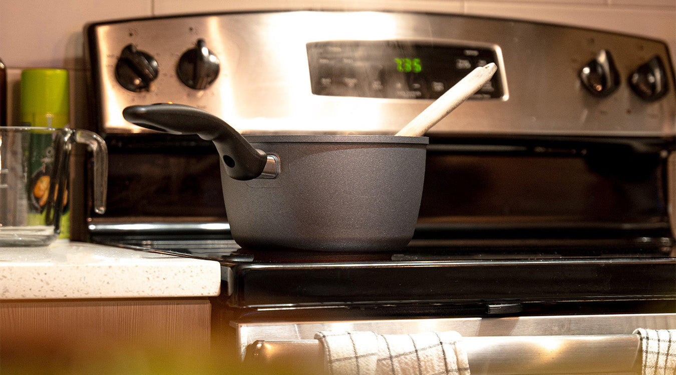 HD saute pan with spoon sitting on kitchen stove top