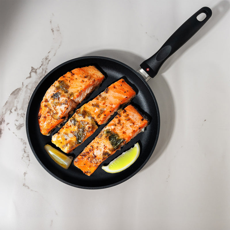 HD Nonstick Fry Pan in use on marble kitchen counter with food inside pan