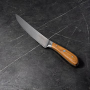 8" Damascus Carving Knife angled view on black kitchen counter