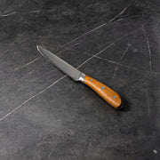5" Damascus Utility Knife angled view on black marble kitchen counter top
