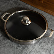 Nonstick Clad 5.3 qt Stainless Chef's Pan with Glass Lid - Induction in use with lid on top and view from above on kitchen counter