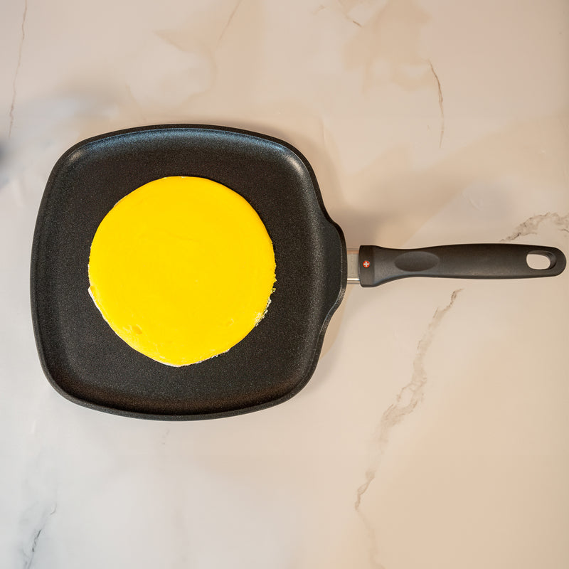 XD Nonstick 11" x 11" Square Griddle - Induction in use with crepe on surface